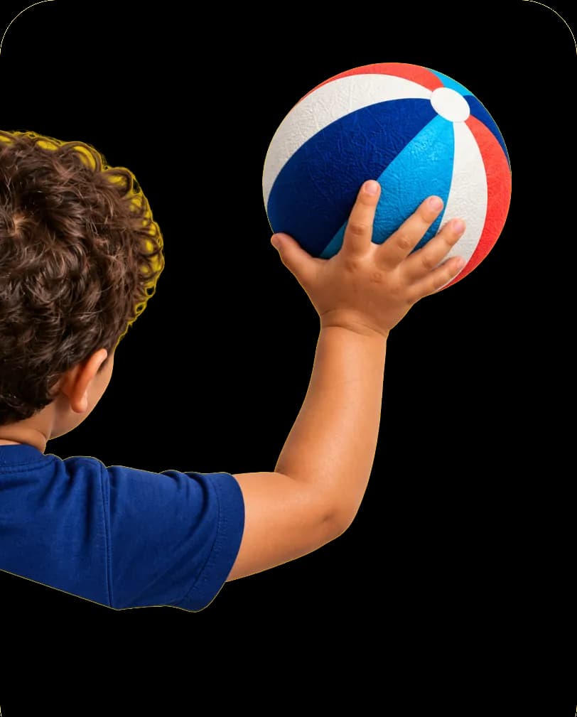 A child holding up a colorful ball