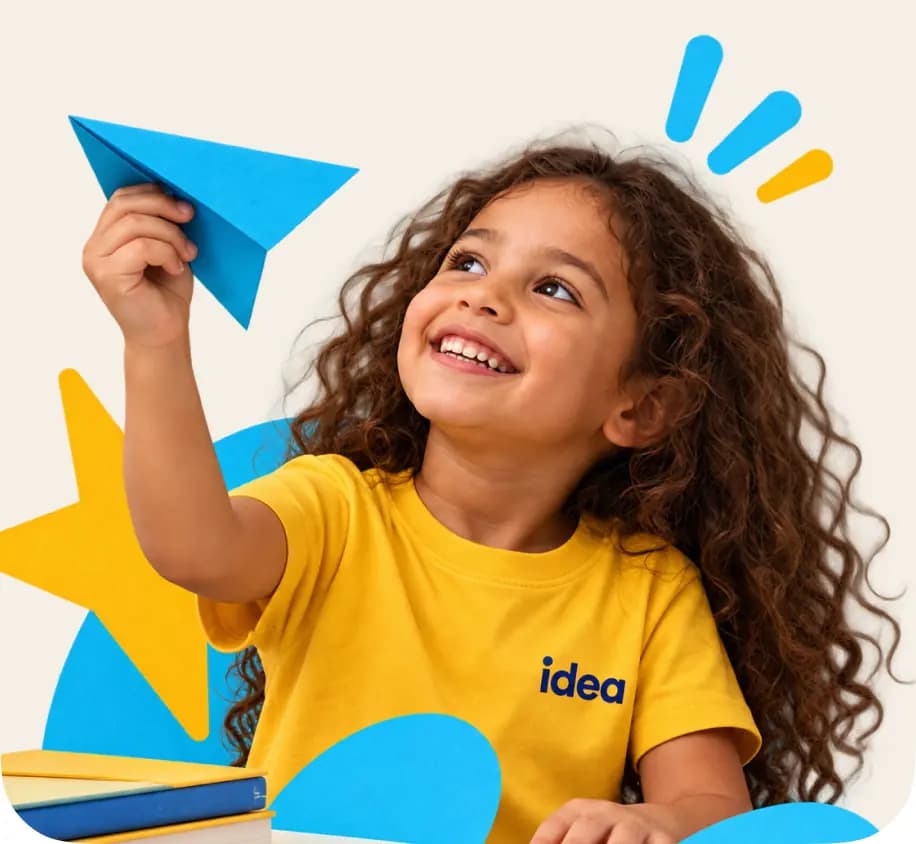 A smiling girl holding a paper airplane